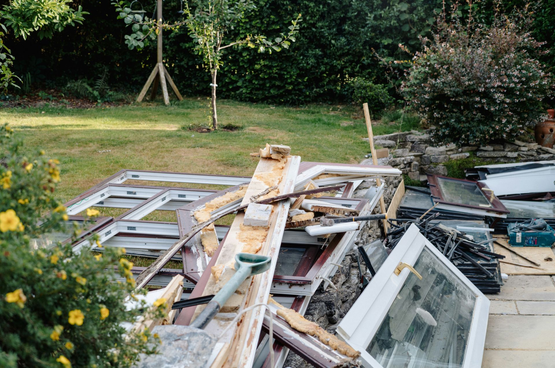 Window frames and wood debris in garden